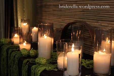 tropical table setting with candles and moss